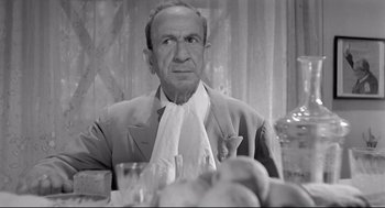 Movie still from “Two Women” (1960), directed by Vittorio De Sica – An older man sitting at a dinner table; Close Up shot, Low angle