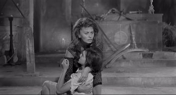 Movie still from “Two Women” (1960), directed by Vittorio De Sica – A black and white photo of a woman holding a child; Medium shot, High angle