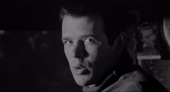 Movie still from “Two Women” (1960), directed by Vittorio De Sica – Black and white photograph of a man in a sweater; Close Up shot, Low angle