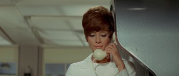 Movie still from “Two for the Road” (1967), directed by Stanley Donen – A woman holding a phone up to her ear; Close Up shot, Low angle