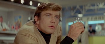 Movie still from “Two for the Road” (1967), directed by Stanley Donen – A person holding a glass of wine; Close Up shot, Low angle