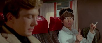 Movie still from “Two for the Road” (1967), directed by Stanley Donen – A man and a woman sitting on a train; Close Up shot, Over the shoulder angle
