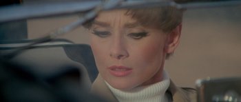 Movie still from “Two for the Road” (1967), directed by Stanley Donen – A person wearing a white sweater; Close Up shot, High angle