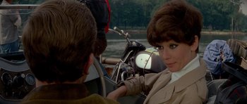 Movie still from “Two for the Road” (1967), directed by Stanley Donen – A woman sitting in a boat on a river; Close Up shot, Over the shoulder angle