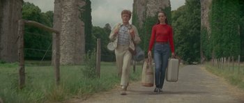 Movie still from “Two for the Road” (1967), directed by Stanley Donen – A man and a woman walking down a dirt road; Wide shot, Low angle