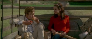 Movie still from “Two for the Road” (1967), directed by Stanley Donen – A man and a woman sitting next to each other on a bench; Medium shot, High angle
