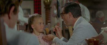 Movie still from “Two for the Road” (1967), directed by Stanley Donen – A man and a little girl eating food together; Close Up shot, Over the shoulder angle
