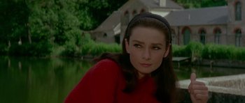 Movie still from “Two for the Road” (1967), directed by Stanley Donen – A woman in a red sweater is looking at the camera; Close Up shot, Over the shoulder angle
