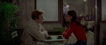 Movie still from “Two for the Road” (1967), directed by Stanley Donen – A man and a woman sitting at a table with coffee cups; Medium shot, Over the shoulder angle