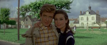 Movie still from “Two for the Road” (1967), directed by Stanley Donen – A man and a woman posing for a picture; Medium shot, Low angle