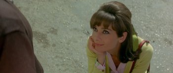 Movie still from “Two for the Road” (1967), directed by Stanley Donen – A beautiful woman with brown hair sitting on the ground; Close Up shot, High angle