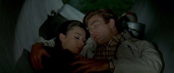 Movie still from “Two for the Road” (1967), directed by Stanley Donen – A man and a woman are sleeping on the ground; Medium shot, High angle