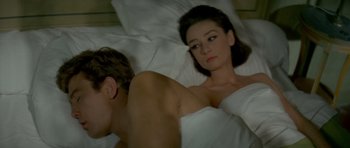 Movie still from “Two for the Road” (1967), directed by Stanley Donen – A man and a woman laying in a bed together; Close Up shot, High angle