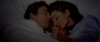 Movie still from “Two for the Road” (1967), directed by Stanley Donen – A man and a woman laying in bed together; Close Up shot, High angle