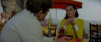 Movie still from “Two for the Road” (1967), directed by Stanley Donen – A man and a woman sitting at an outdoor table; Medium shot, Over the shoulder angle