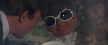 Movie still from “Two for the Road” (1967), directed by Stanley Donen – A person wearing sunglasses; Close Up shot, Low angle