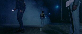 Movie still from “Two-Lane Blacktop” (1971), directed by Monte Hellman – A person standing on the side of a road at night; Wide shot, Low angle