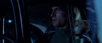 Movie still from “Two-Lane Blacktop” (1971), directed by Monte Hellman – A person sitting in a car at night; Close Up shot, Low angle