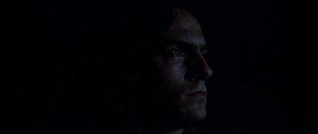 Movie still from “Two-Lane Blacktop” (1971), directed by Monte Hellman – A person's face in the dark; Close Up shot, Low angle