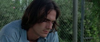 Movie still from “Two-Lane Blacktop” (1971), directed by Monte Hellman – A person with long brown hair; Close Up shot, Low angle