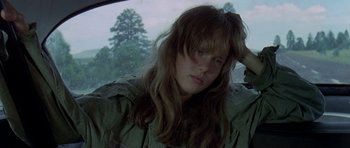 Movie still from “Two-Lane Blacktop” (1971), directed by Monte Hellman – A woman sitting in the back seat of a car; Close Up shot, Low angle