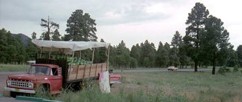 Movie still from “Two-Lane Blacktop” (1971), directed by Monte Hellman – A wagon filled with cantaloupe sits in a field; Extreme Wide shot, High angle