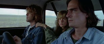 Movie still from “Two-Lane Blacktop” (1971), directed by Monte Hellman – A group of people sitting in the back of a vehicle; Close Up shot, Low angle