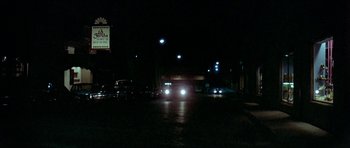 Movie still from “Two-Lane Blacktop” (1971), directed by Monte Hellman – A bus driving down a street at night; Extreme Wide shot, High angle