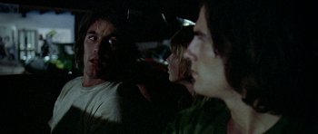 Movie still from “Two-Lane Blacktop” (1971), directed by Monte Hellman – A group of people sitting next to each other in a car; Close Up shot, Over the shoulder angle