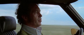 Movie still from “Two-Lane Blacktop” (1971), directed by Monte Hellman – A person in a car looking out the window; Close Up shot, Low angle
