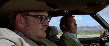 Movie still from “Two-Lane Blacktop” (1971), directed by Monte Hellman – Two men sitting in the back seat of a car; Close Up shot, Low angle