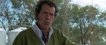 Movie still from “Two-Lane Blacktop” (1971), directed by Monte Hellman – A person wearing a green sweater; Close Up shot, Low angle