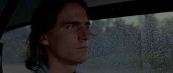 Movie still from “Two-Lane Blacktop” (1971), directed by Monte Hellman – A person looking out a car window; Close Up shot, Low angle