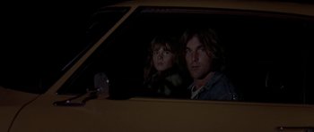 Movie still from “Two-Lane Blacktop” (1971), directed by Monte Hellman – A man and a child in a car at night; Close Up shot, Low angle