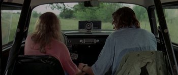Movie still from “Two-Lane Blacktop” (1971), directed by Monte Hellman – A man and a woman sitting in the drivers seat of a car; Medium shot, Over the shoulder angle
