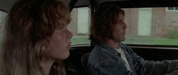 Movie still from “Two-Lane Blacktop” (1971), directed by Monte Hellman – A man and a woman sitting in the back of a car; Close Up shot, Low angle