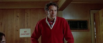 Movie still from “Two-Lane Blacktop” (1971), directed by Monte Hellman – A man wearing a red sweater and a blue tie; Close Up shot, Low angle