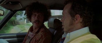 Movie still from “Two-Lane Blacktop” (1971), directed by Monte Hellman – Two men sitting in the back seat of a car; Close Up shot, Over the shoulder angle