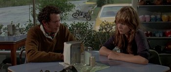 Movie still from “Two-Lane Blacktop” (1971), directed by Monte Hellman – A man and a woman sitting at a table; Medium shot, Over the shoulder angle