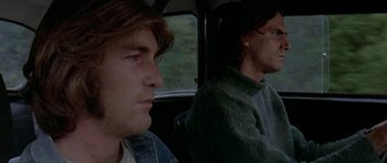 Movie still from “Two-Lane Blacktop” (1971), directed by Monte Hellman – Two men sitting in the back seat of a car; Close Up shot, Low angle