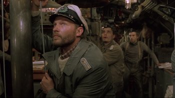 Movie still from “U-571” (2000), directed by Jonathan Mostow – A group of men standing next to each other in a room; Medium shot, Low angle