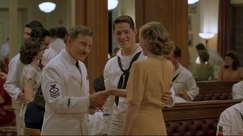 Movie still from “U-571” (2000), directed by Jonathan Mostow – A couple of people that are shaking hands; Medium shot, Over the shoulder angle