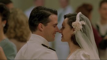 Movie still from “U-571” (2000), directed by Jonathan Mostow – A man and a woman are kissing each other; Close Up shot, Low angle