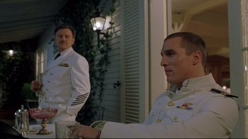 Movie still from “U-571” (2000), directed by Jonathan Mostow – Two men dressed in naval uniforms standing next to each other; Medium shot, Low angle