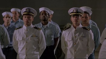 Movie still from “U-571” (2000), directed by Jonathan Mostow – A group of men standing next to each other wearing uniforms; Medium shot, Low angle