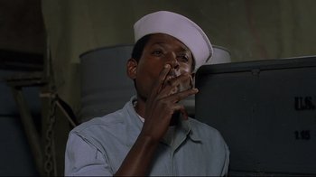 Movie still from “U-571” (2000), directed by Jonathan Mostow – A man wearing a sailor's hat smoking a cigarette; Close Up shot, Low angle