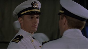 Movie still from “U-571” (2000), directed by Jonathan Mostow – A man in a military uniform is talking to another man in a uniform; Close Up shot, Low angle