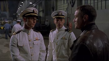 Movie still from “U-571” (2000), directed by Jonathan Mostow – A group of men standing next to each other in uniform; Medium shot, Over the shoulder angle