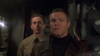 Movie still from “U-571” (2000), directed by Jonathan Mostow – A man in a brown jacket and a man in a tan jacket; Close Up shot, Low angle