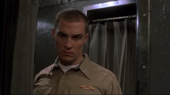 Movie still from “U-571” (2000), directed by Jonathan Mostow – A person wearing a military uniform; Close Up shot, Low angle